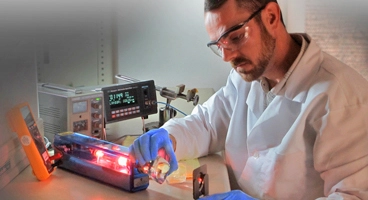 student using a laser for an experiment
